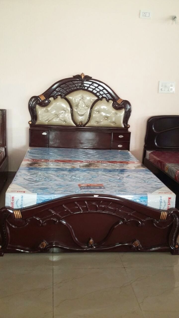 Carved wood bed with tufted cream headboard