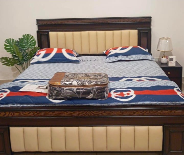 Dark wood bed with cream leatherette panel headboard