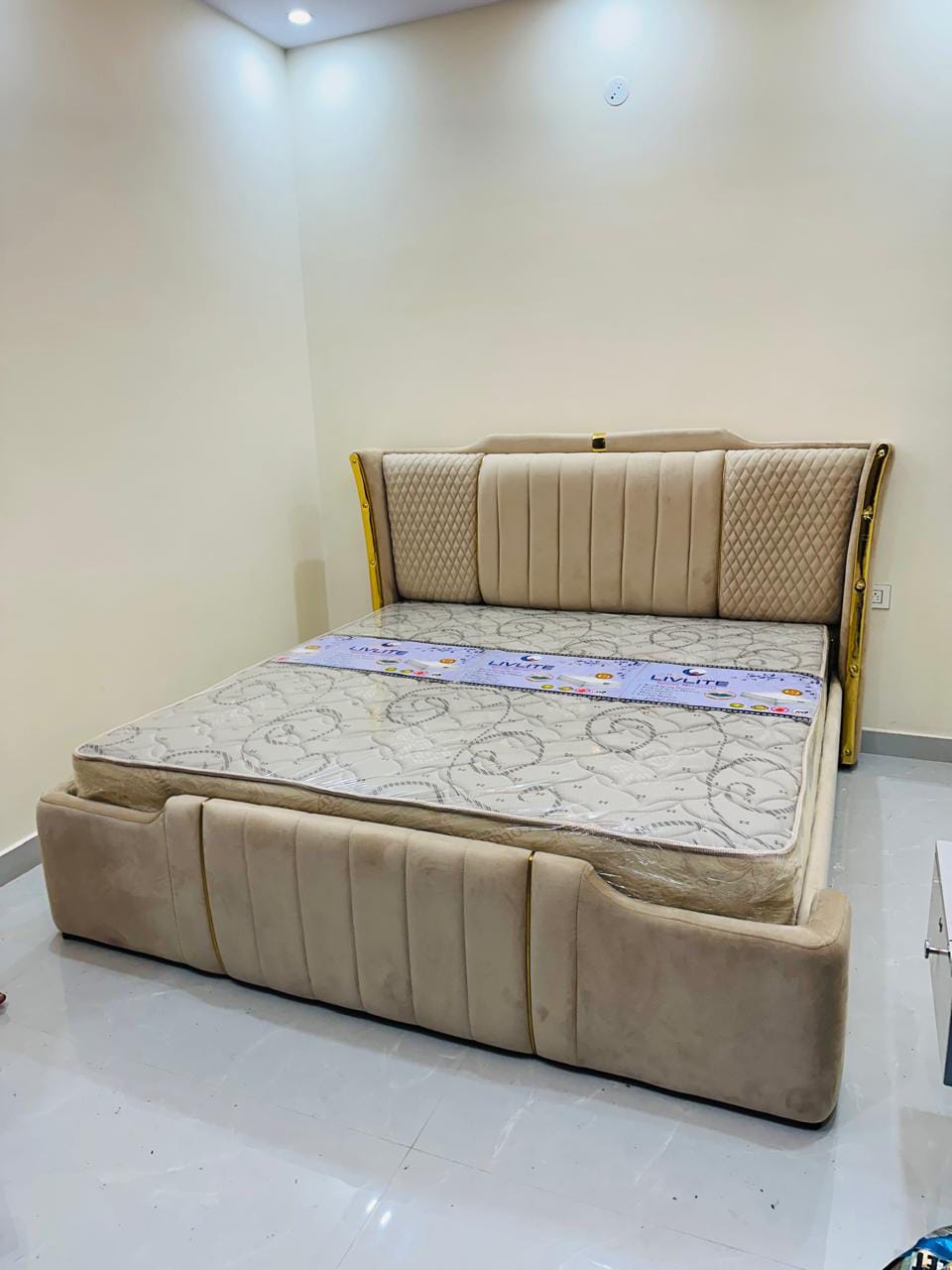 Beige velvet bed with gold trim