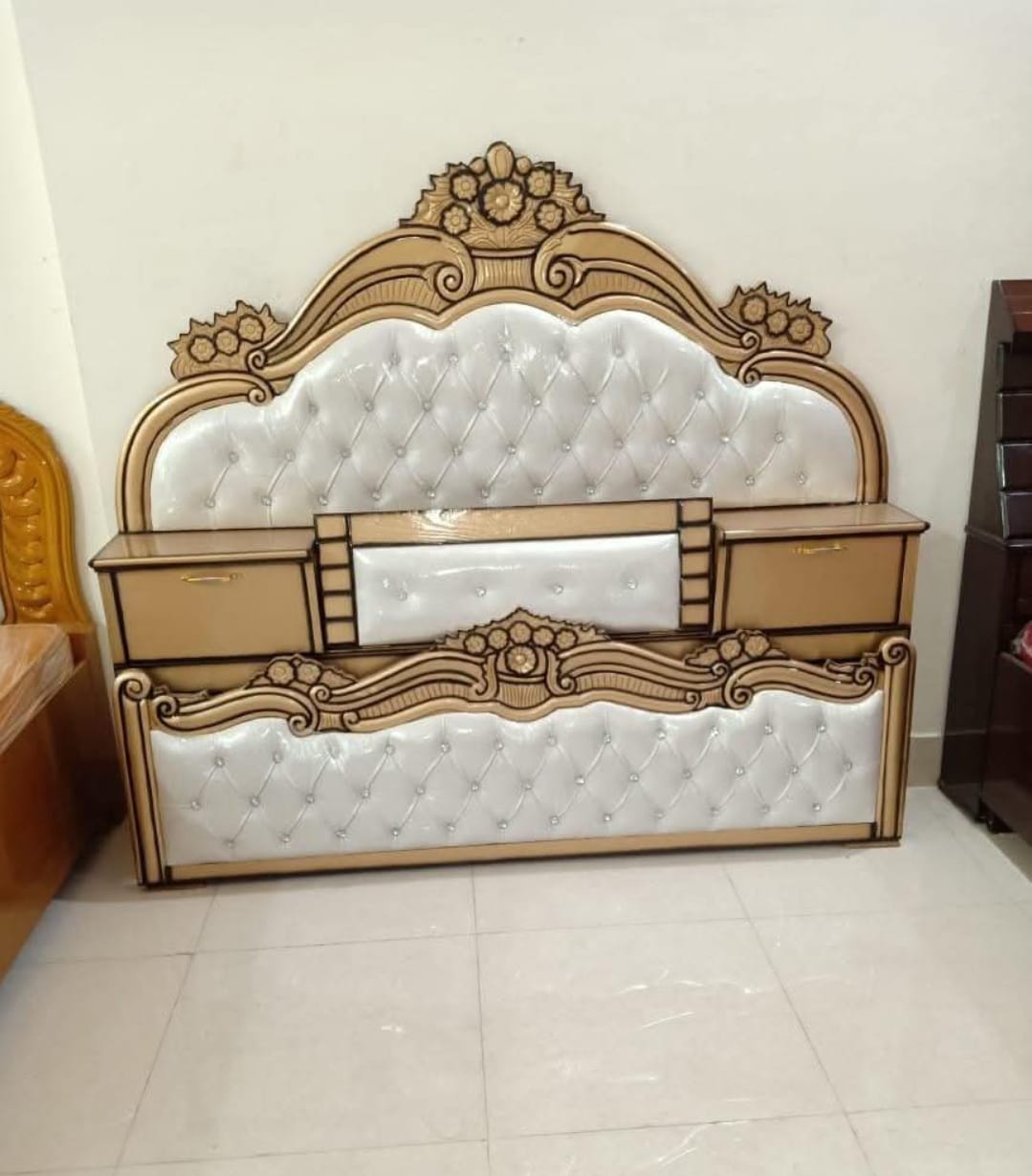 Ornate tufted bed with attached side tables