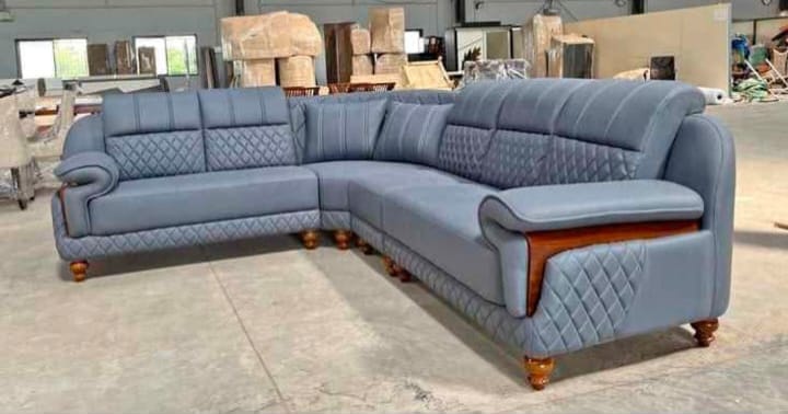 Blue-grey quilted corner sofa with wooden trim