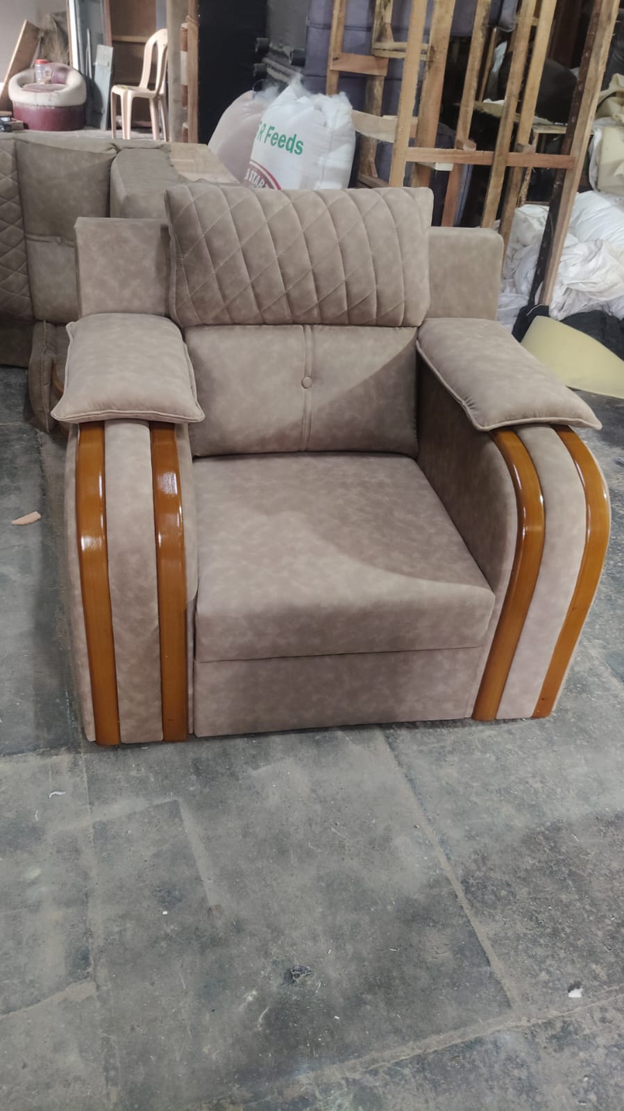 Beige recliner armchair with glossy wood trim