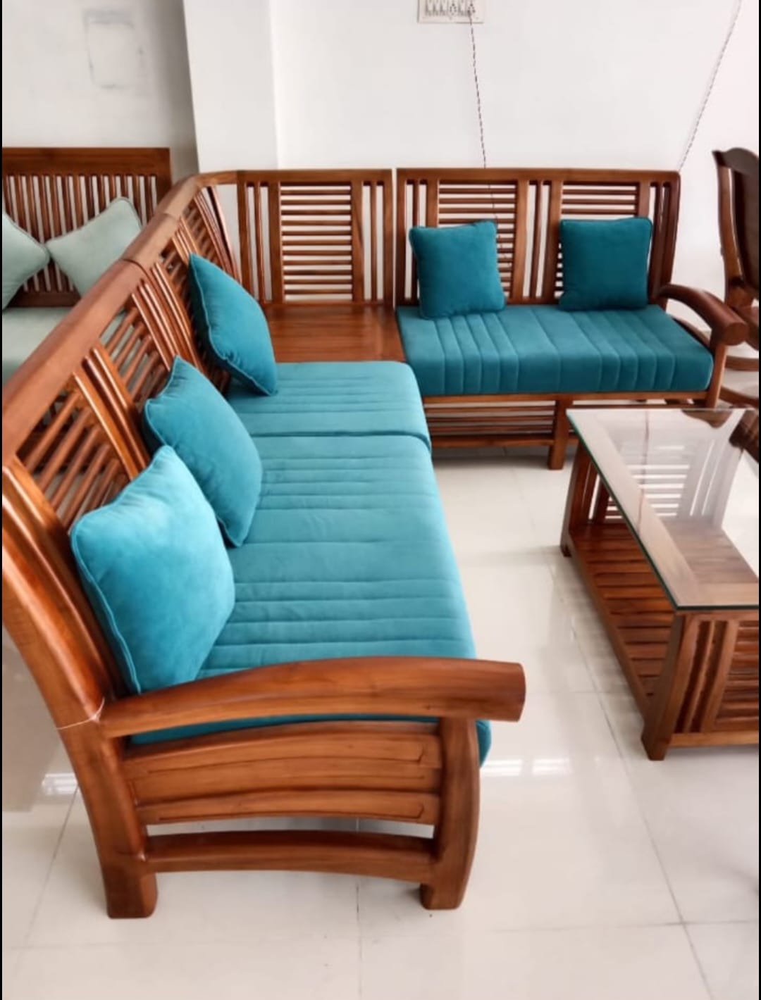 Teal cushions on slatted wood corner sofa