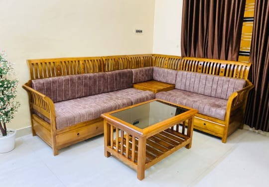 Mauve cushions on wooden slatted corner sofa